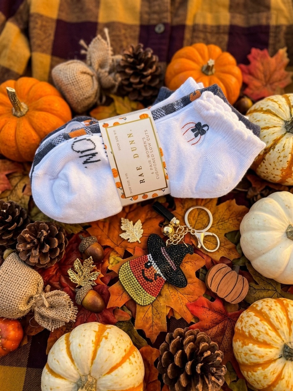 Rae Dunn No-Show Socks with Orange fall Motifs and a candycorn witch bag charm